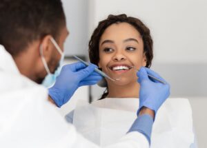A woman is receiving dental care from a dentist.