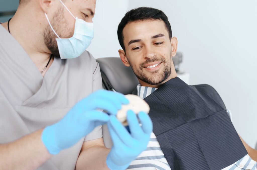 Dentist talks with patient about restorative dentist in Austin, TX